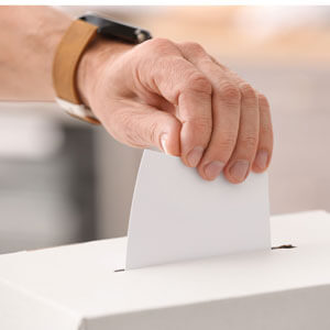 Voting Young Man Near Ballot Box